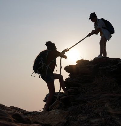 woman-traveler-pulls-hands-her-friend-up-from-ideas-success-teamwork-leadership_43430-173